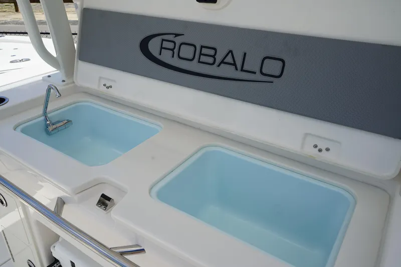 Slide: The Image of 2025 Robalo R300 Center Console boat with dual sinks and faucet. - 21