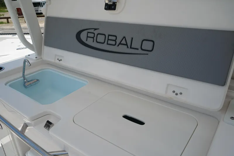 Slide: The Image of 2025 Robalo R300 Center Console boat sink and storage area. - 22