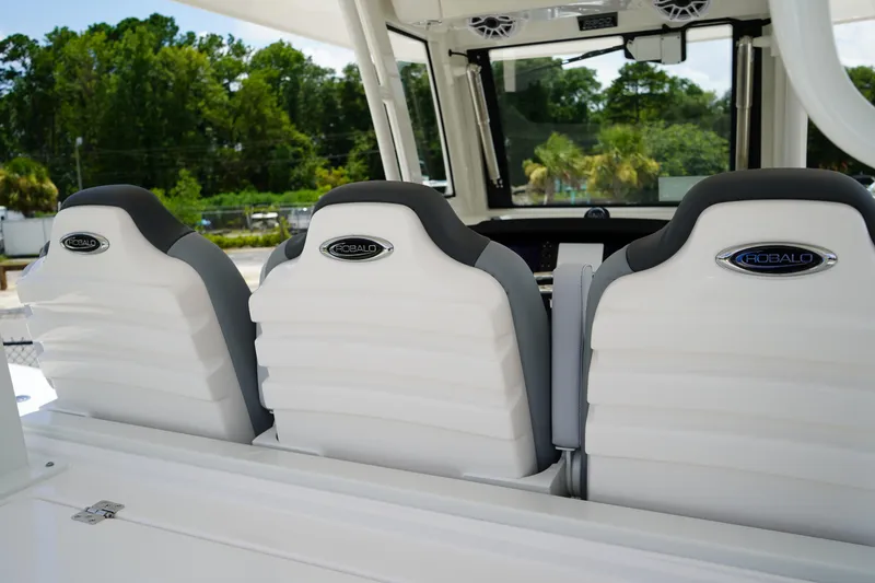 Slide: The Image of 2025 Robalo R300 Center Console boat seats, white and gray, with logo, outdoor setting. - 25