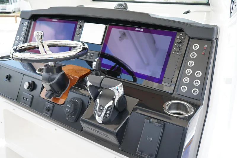 Slide: The Image of 2025 Robalo R300 Center Console dashboard with dual Simrad displays and modern controls. - 32