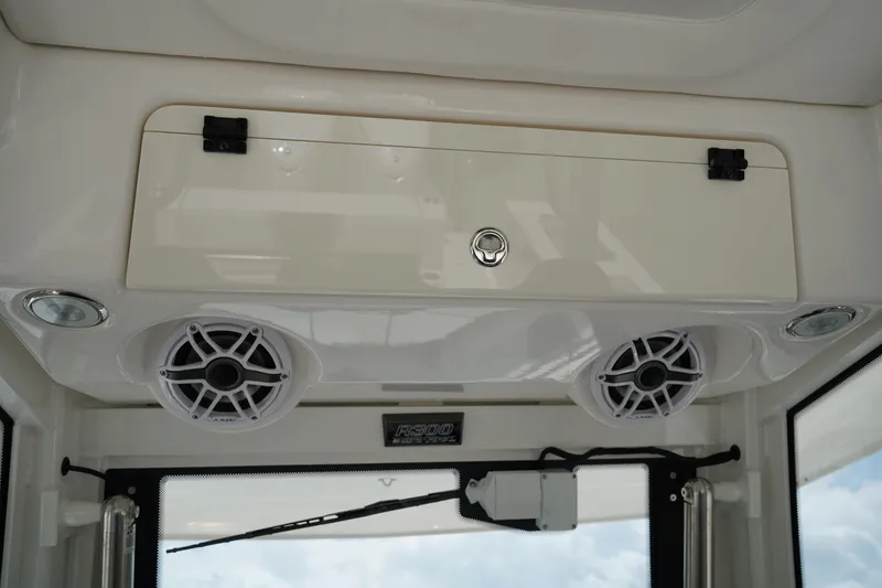 Slide: The Image of 2025 Robalo R300 Center Console interior with speakers and storage compartment. - 34