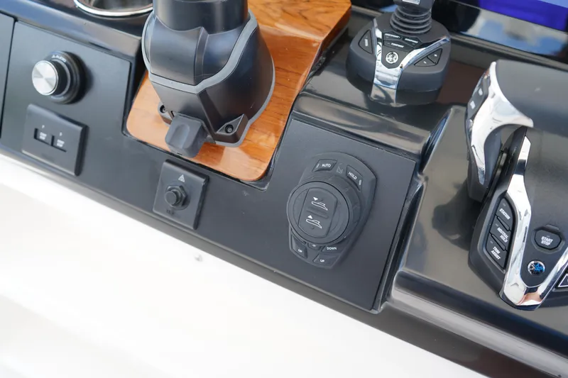 Slide: The Image of 2025 Robalo R300 Center Console boat dashboard with modern controls and switches. - 37