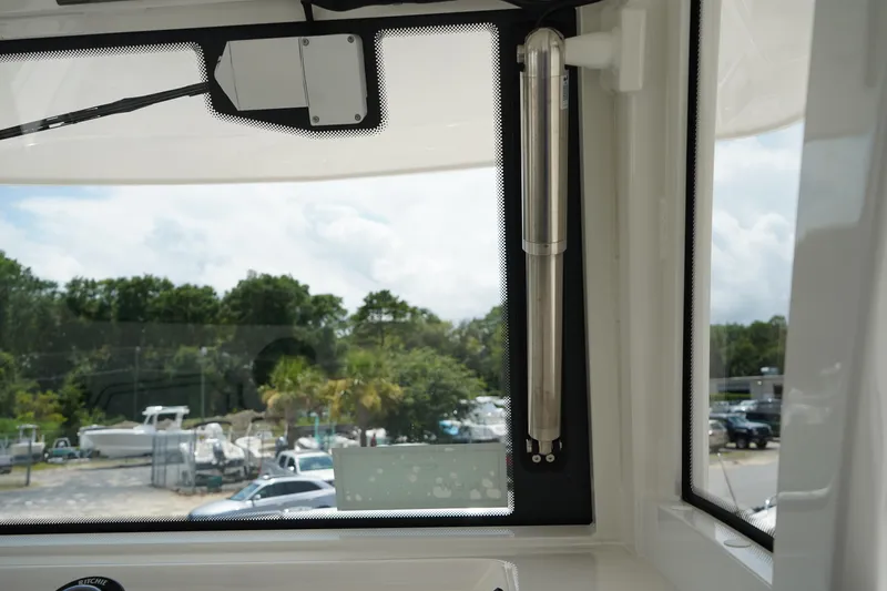 Slide: The Image of Interior view of 2025 Robalo R300 Center Console boat, showcasing window and surroundings. - 44