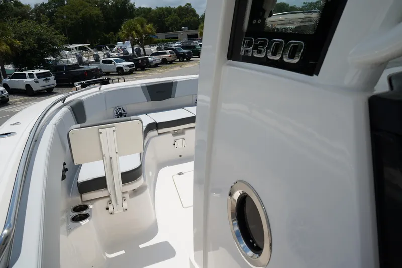 Slide: The Image of 2025 Robalo R300 Center Console boat interior with seating and cup holders. - 47