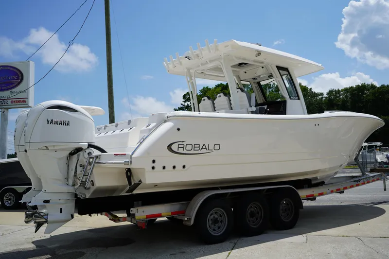 Slide: The Image of 2025 Robalo R300 Center Console boat on trailer, featuring Yamaha engines. - 5