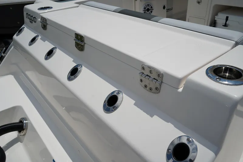 Slide: The Image of 2025 Robalo R300 Center Console boat with rod holders and storage compartment. - 8