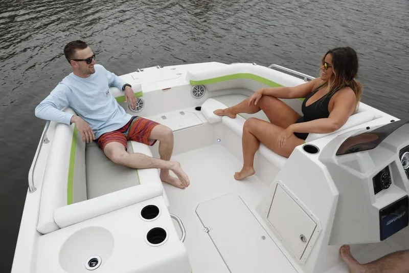 Slide: The Image of Two people relaxing on a 2025 Starcraft 191 SVX boat. - 11