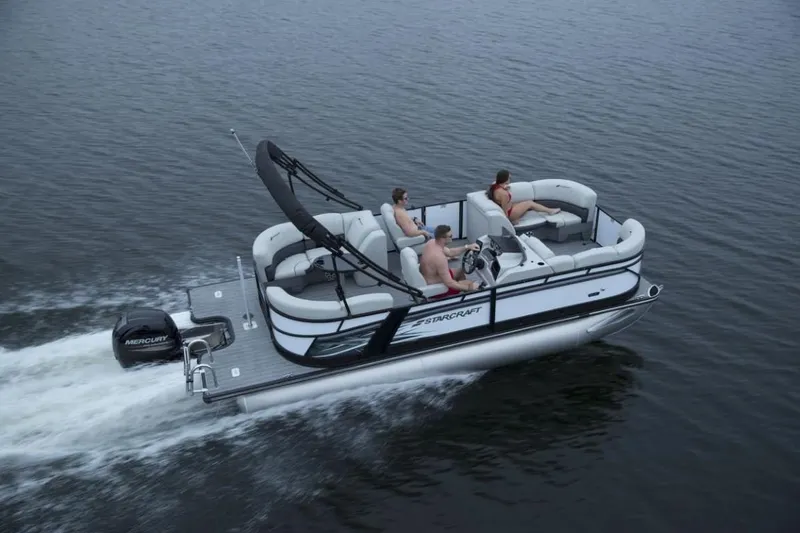 Slide: The Image of 2025 Starcraft SLS 1 pontoon boat cruising on a calm lake. - 4