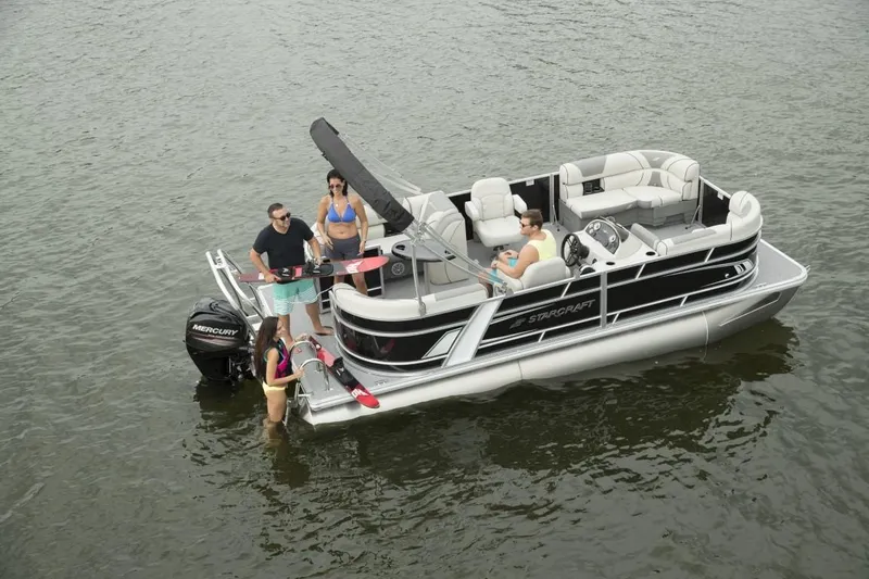 Slide: The Image of 2025 Starcraft EX 20 pontoon boat with people enjoying water activities. - 3