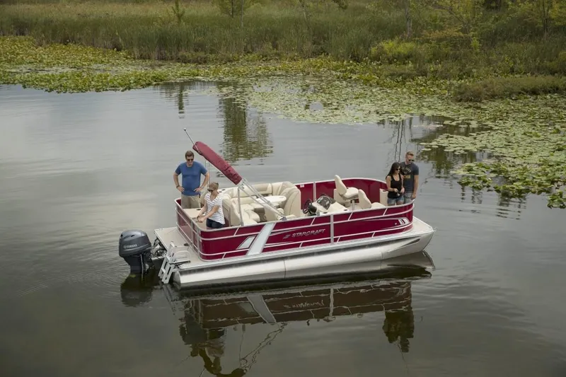 Slide: The Image of 2025 Starcraft EX 20 pontoon boat on a calm lake with passengers. - 8