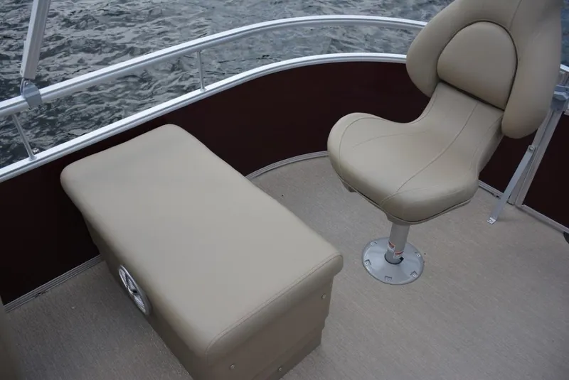 Slide: The Image of 2025 Starcraft 20 LX boat interior with beige seating and water view. - 17