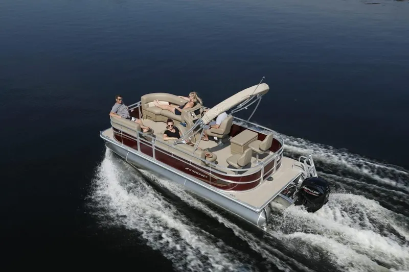 Slide: The Image of 2025 Starcraft 20 LX pontoon boat cruising on calm water with passengers onboard. - 5