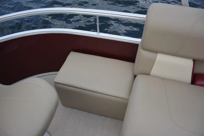 Slide: The Image of 2025 Starcraft 20 LX boat interior with beige seating and water view. - 9