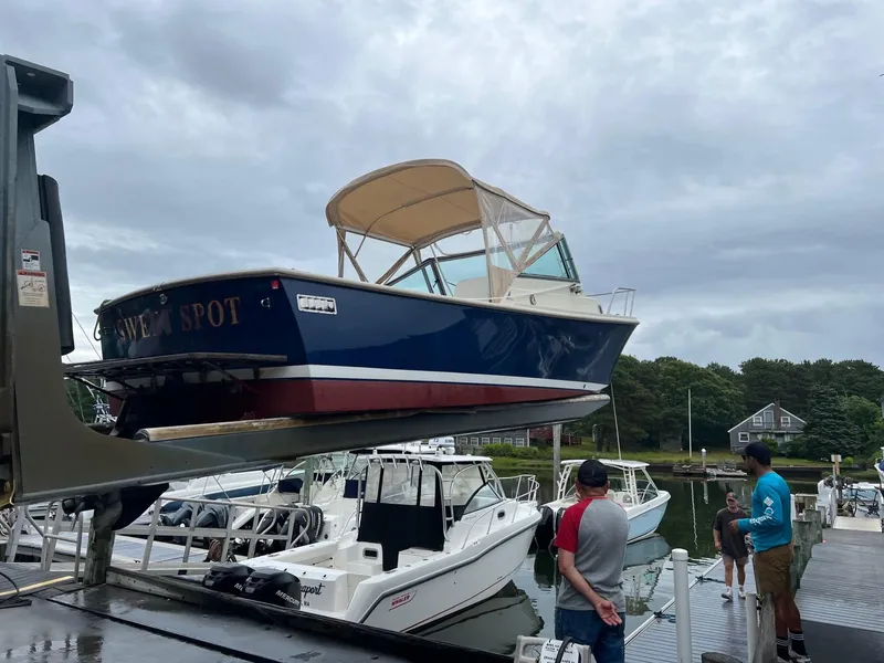 Slide: The Image of Holby 24 Pilot 2005 boat being lifted at a marina, surrounded by people and other boats. - 14