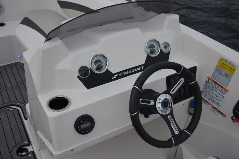Slide: The Image of 2023 Starcraft 211 SVX boat dashboard with steering wheel and gauges. - 12