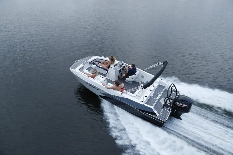 Slide: The Image of 2023 Starcraft 211 SVX boat cruising on open water with passengers onboard. - 4