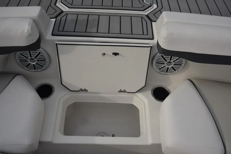Slide: The Image of 2023 Starcraft 211 SVX boat interior with seating, speakers, and storage compartment. - 6