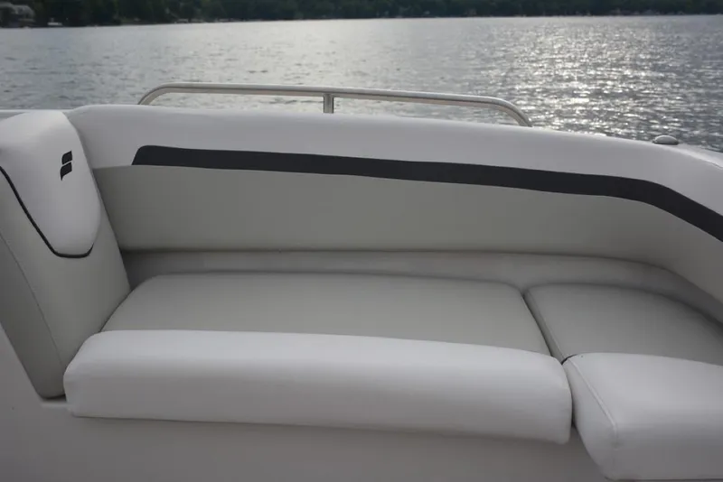 Slide: The Image of 2023 Starcraft 211 SVX boat interior with cushioned seating by the water. - 7