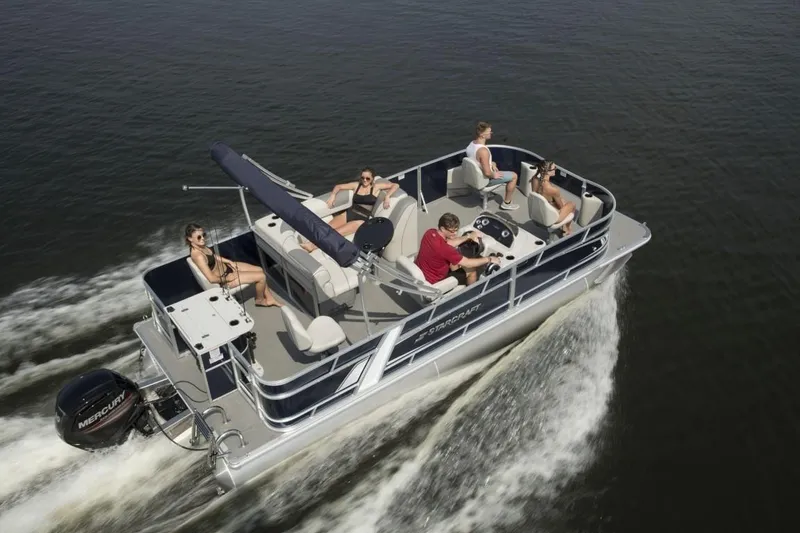 Slide: The Image of 2025 Starcraft EX 22 pontoon boat cruising with passengers on a lake. - 4