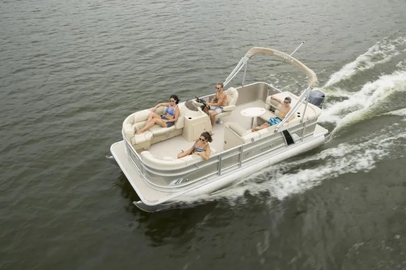 Slide: The Image of 2025 Starcraft 22 LX pontoon boat cruising with passengers on a lake. - 4