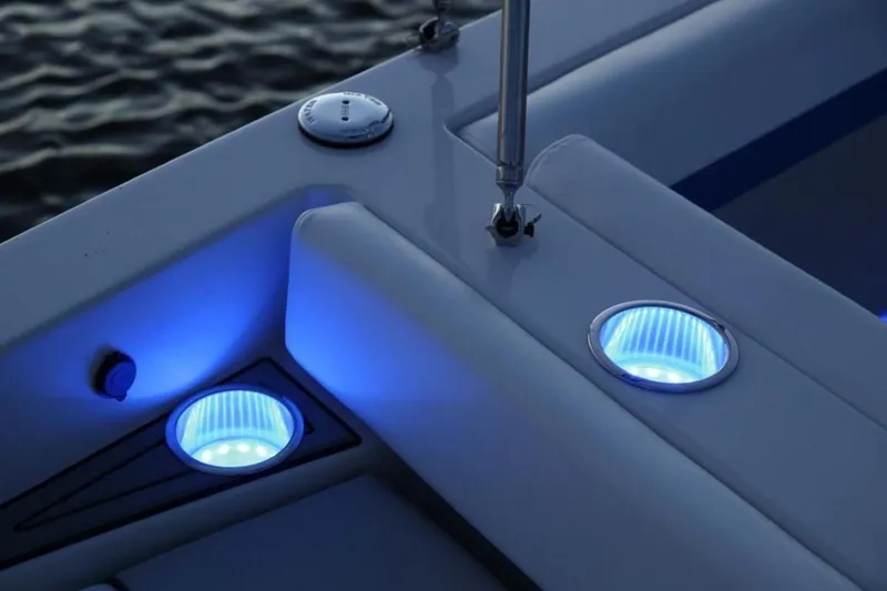 Slide: The Image of 2025 Starcraft 231 SVX boat with blue LED deck lights at dusk. - 15