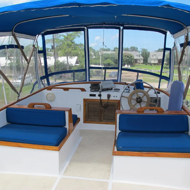 Slide: The Image of 1981 Albin 36 boat cockpit with blue seating and steering wheel. - 12