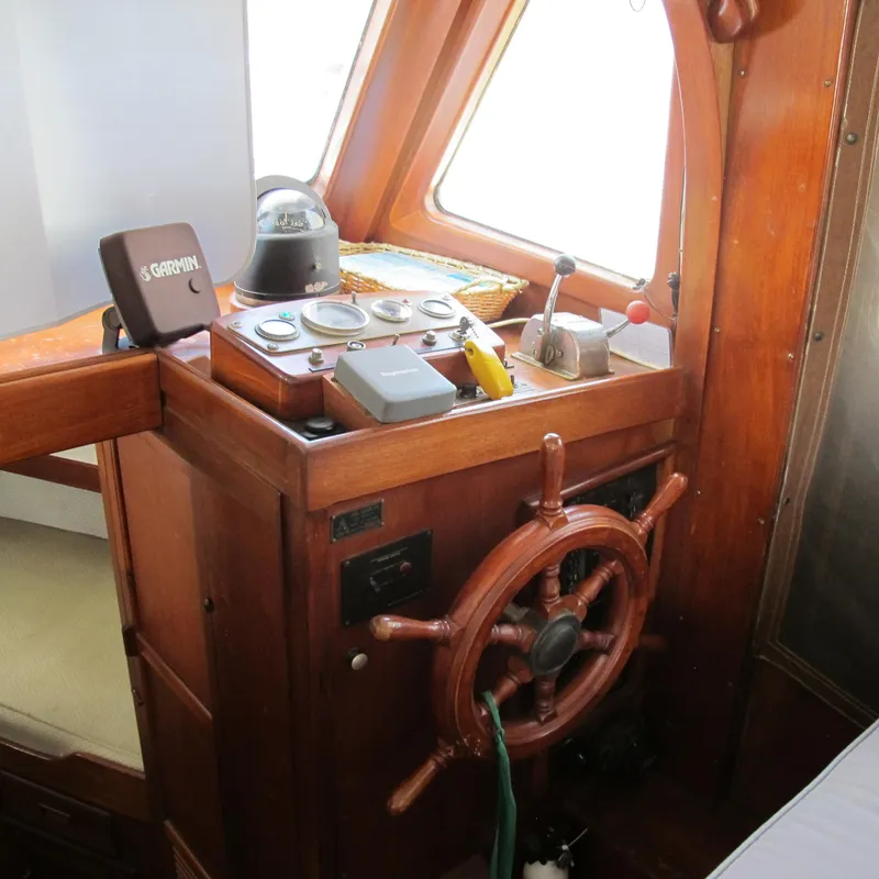 Slide: The Image of 1981 Albin 36 boat helm with wooden wheel and navigation instruments. - 14