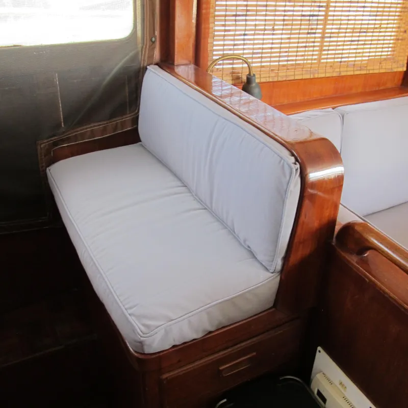Slide: The Image of Interior of 1981 Albin 36 boat with cushioned seating and wooden accents. - 16