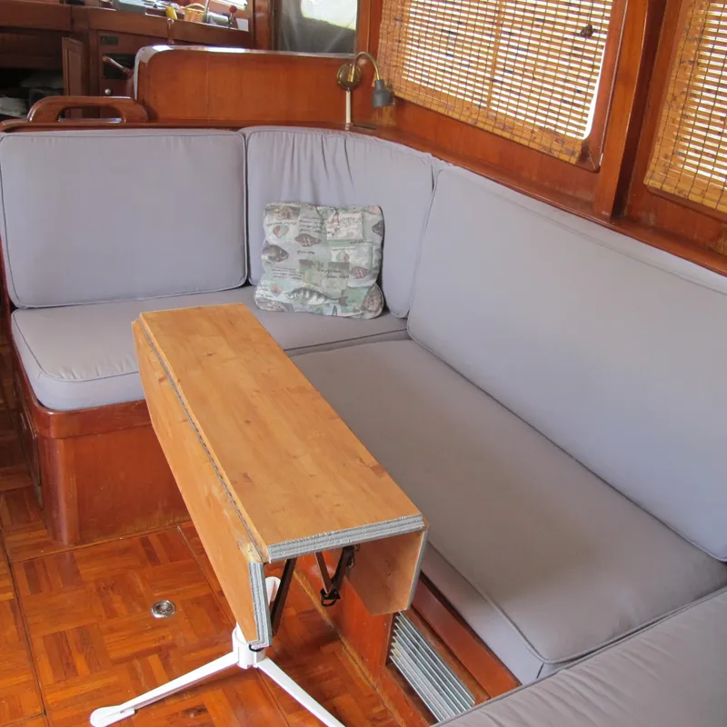 Slide: The Image of Interior of 1981 Albin 36 boat with cozy seating and wooden table. - 17