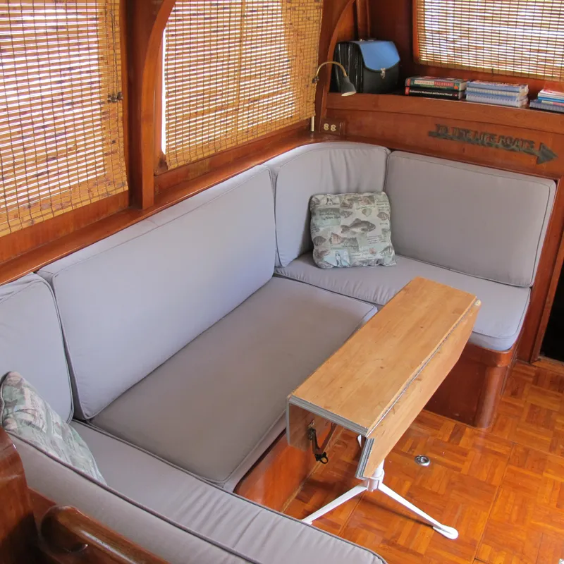 Slide: The Image of Cozy interior of 1981 Albin 36 boat with cushioned seating and wooden table. - 18