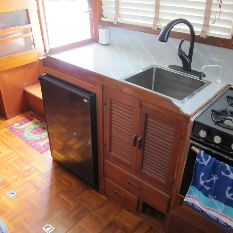 Slide: The Image of 1981 Albin 36 boat kitchen with sink, stove, and mini fridge. - 19