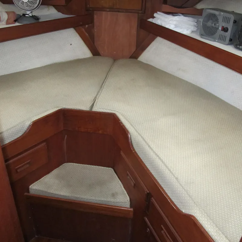 Slide: The Image of 1981 Albin 36 boat interior with beige cushions and wooden cabinetry. - 22