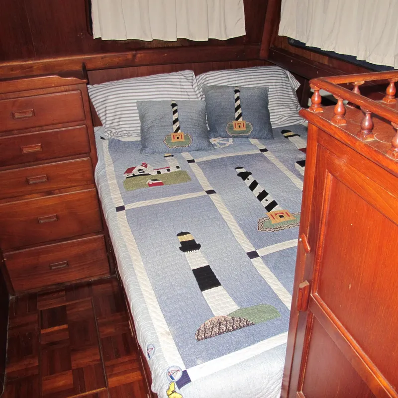 Slide: The Image of Cozy cabin bedroom in 1981 Albin 36 boat with lighthouse-themed bedding. - 26