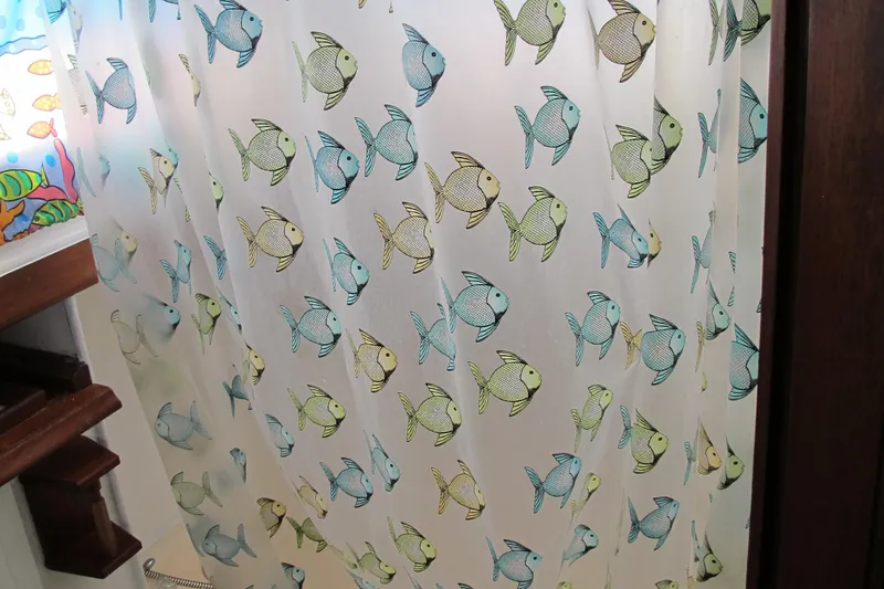 Slide: The Image of Colorful fish-patterned curtain inside a 1981 Albin 36 boat. - 30