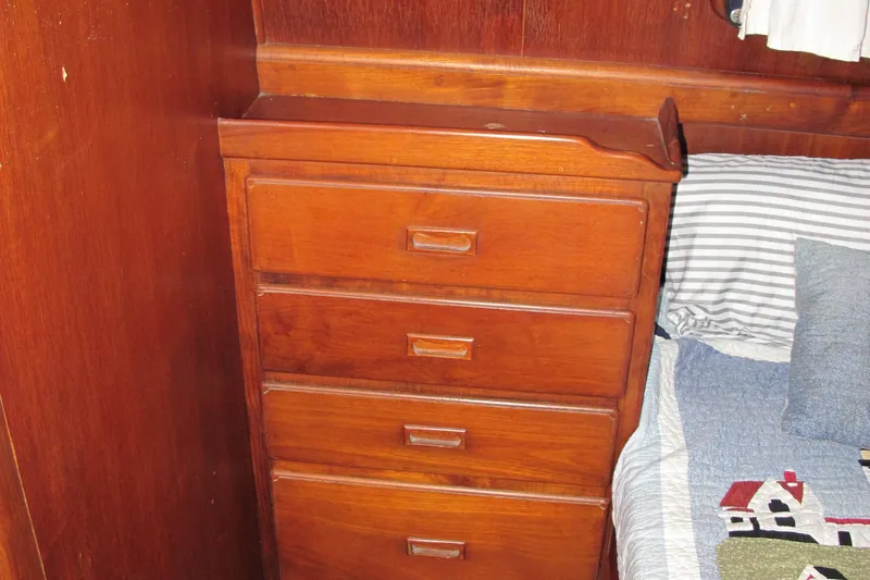 Slide: The Image of Wooden dresser beside bed in 1981 Albin 36 boat cabin interior. - 32