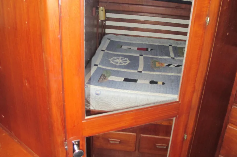 Slide: The Image of Cozy cabin interior of 1981 Albin 36 boat with nautical-themed bedding. - 34