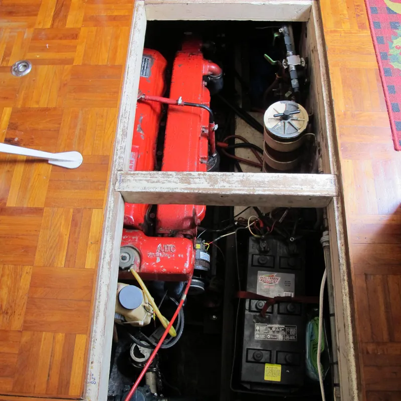 Slide: The Image of Engine compartment of a 1981 Albin 36 boat with visible red engine components. - 35