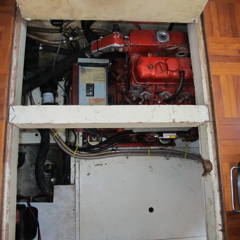 Slide: The Image of Engine compartment of a 1981 Albin 36 boat, featuring a red engine and various components. - 37