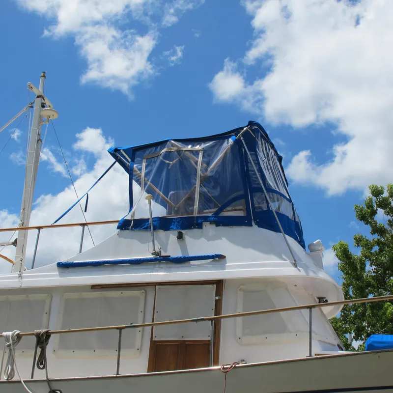 Slide: The Image of 1981 Albin 36 boat with blue canopy against a bright sky. - 4