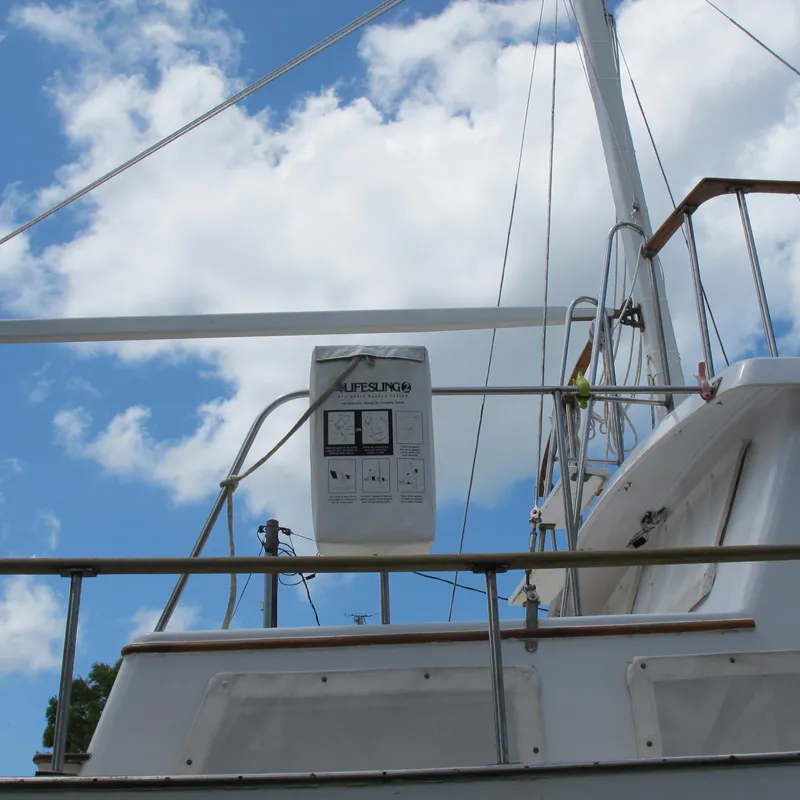 Slide: The Image of 1981 Albin 36 sailboat with Lifesling, blue sky background. - 5
