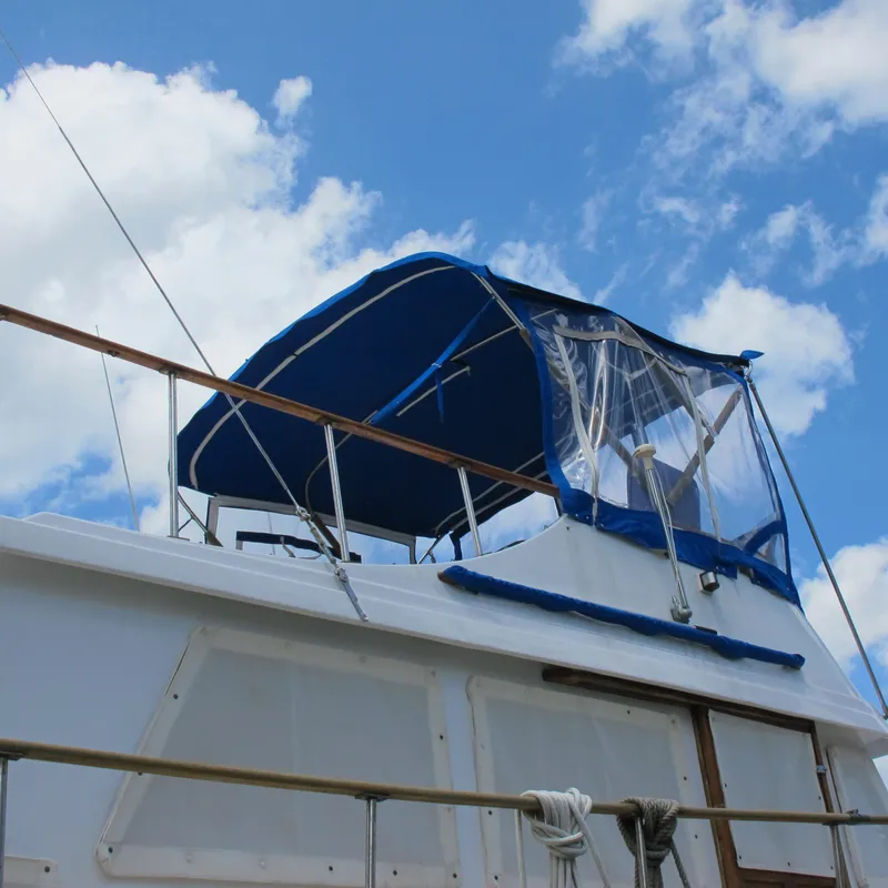 Slide: The Image of 1981 Albin 36 boat with blue canopy against a cloudy sky. - 6