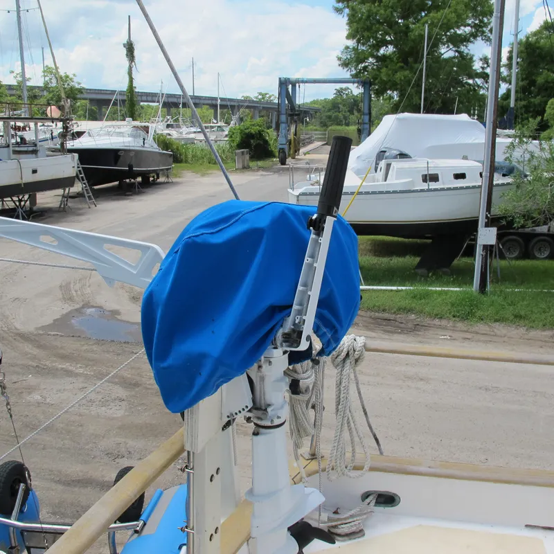Slide: The Image of 1981 Albin 36 sailboat with blue cover in a marina setting. - 8