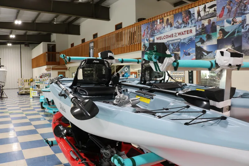 The Image of 2023 Hobie Mirage Passport 12.0 R kayak displayed in a showroom with vibrant decor. - 0