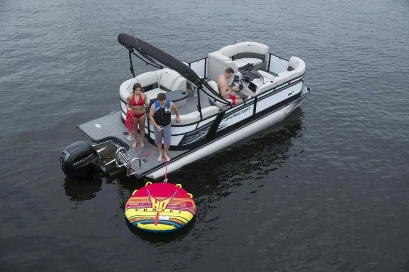 Slide: The Image of 2025 Starcraft SLS 3 pontoon boat with people enjoying water activities. - 2