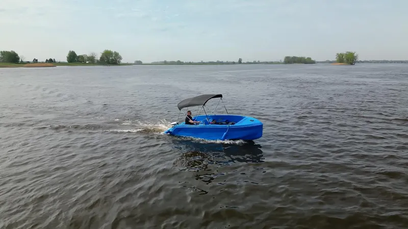 Slide: The Image of 2024 Vision Marine Technologies Phantom boat cruising on a calm lake. - 4