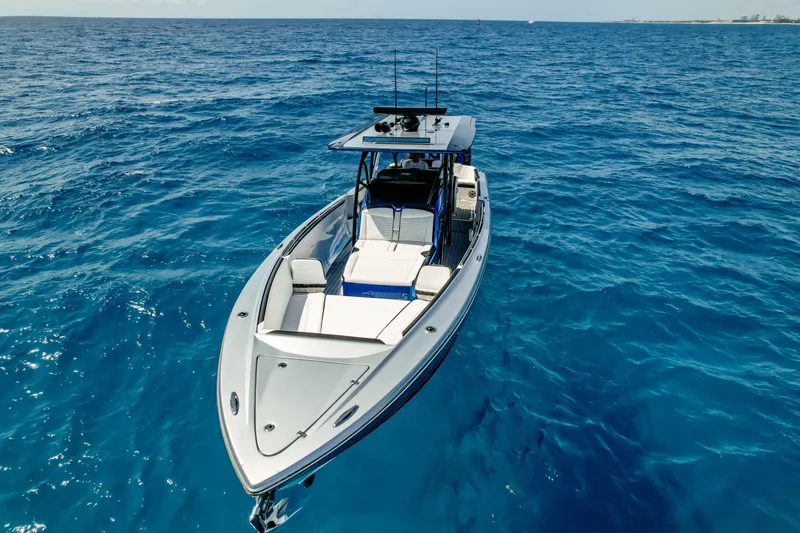 Slide: The Image of 2022 Nor-Tech 390 Center Console boat on open blue ocean. - 12