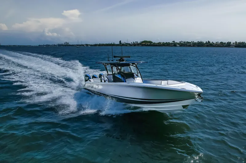Slide: The Image of 2022 Nor-Tech 390 Center Console boat cruising on open water. - 21
