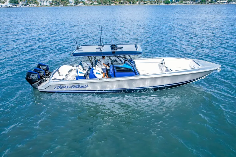 Slide: The Image of 2022 Nor-Tech 390 Center Console boat on calm blue water. - 3