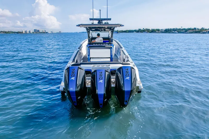 Slide: The Image of 2022 Nor-Tech 390 Center Console boat with four powerful 450R engines on open water. - 4