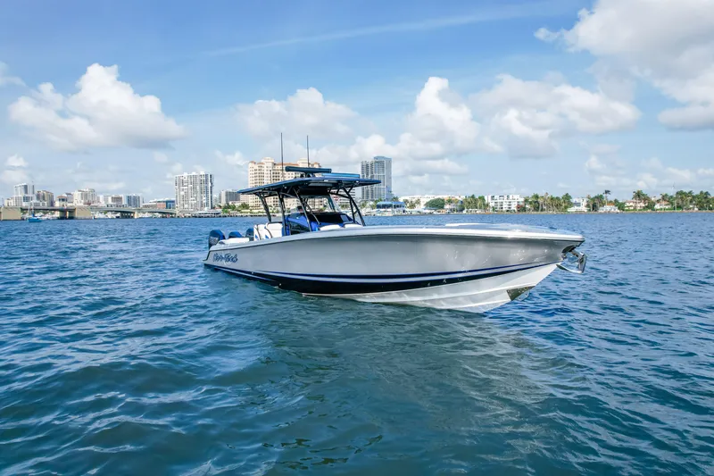 Slide: The Image of 2022 Nor-Tech 390 Center Console boat on water with city skyline background. - 9
